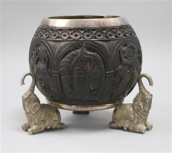 A carved coconut, mounted with elephants
